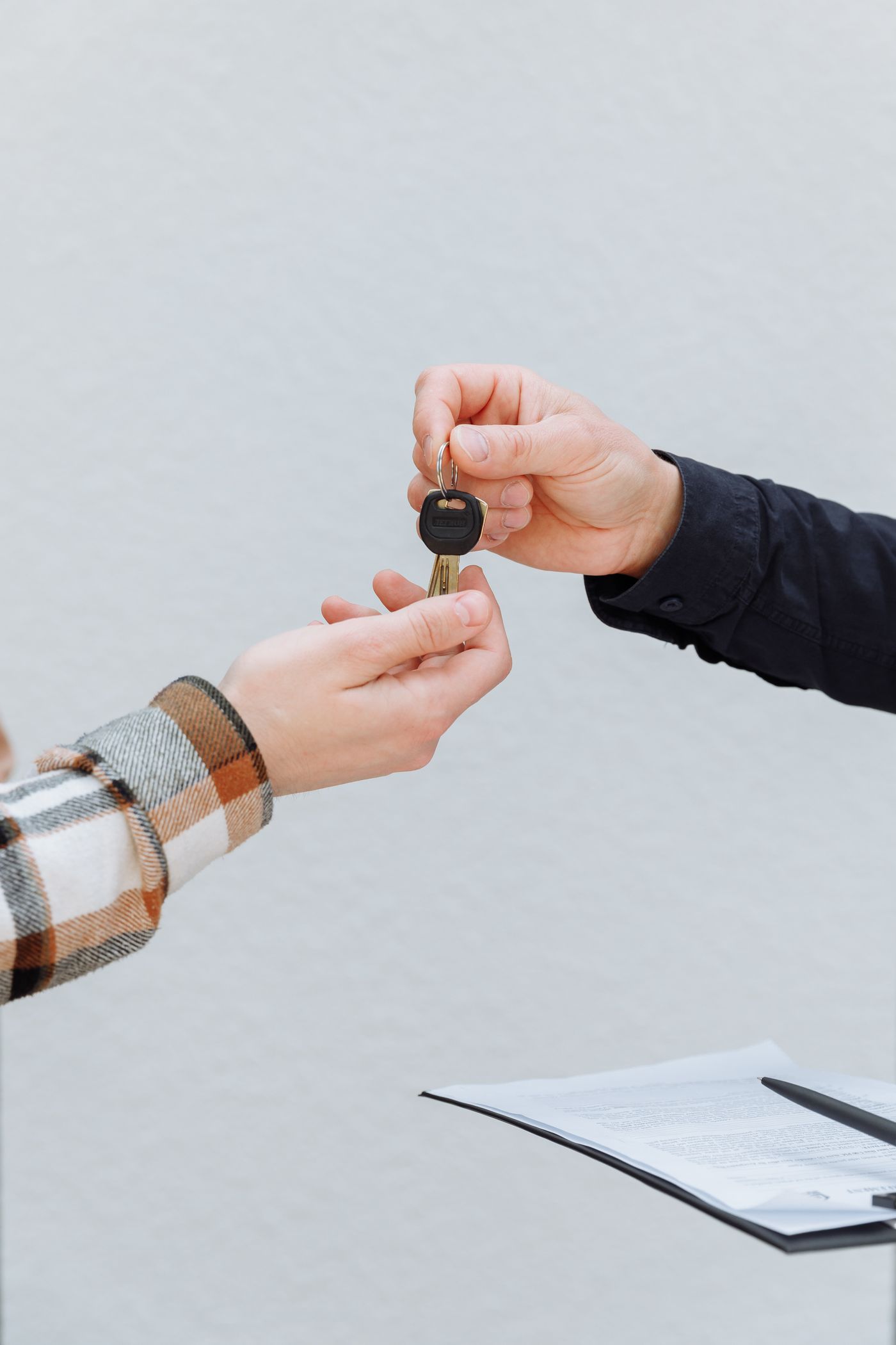 One person handing over a set of car keys to another