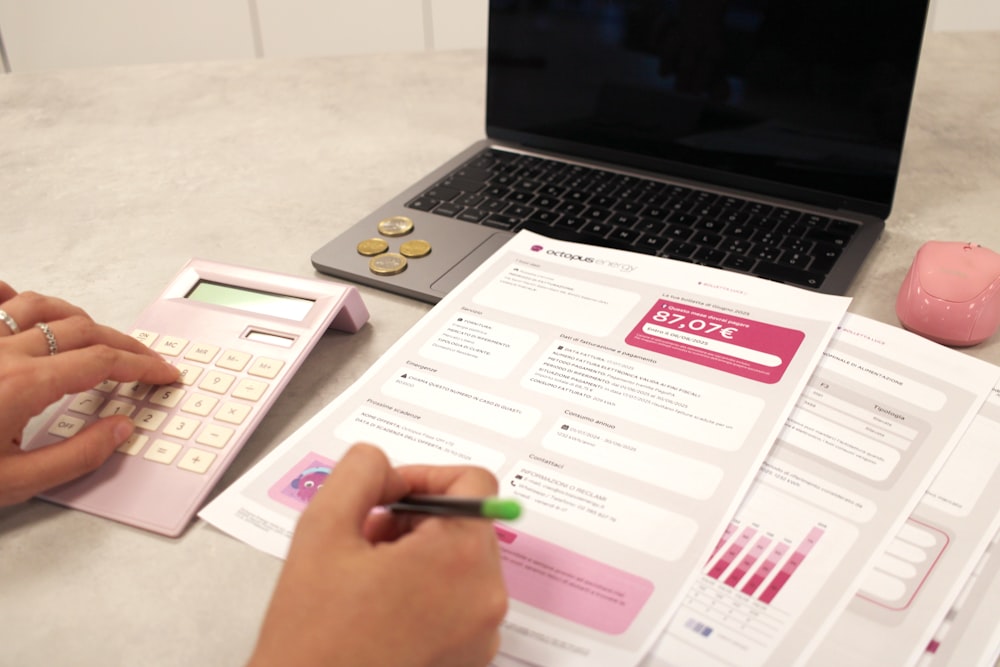 Someone reviewing financial documents and bills at a desk
